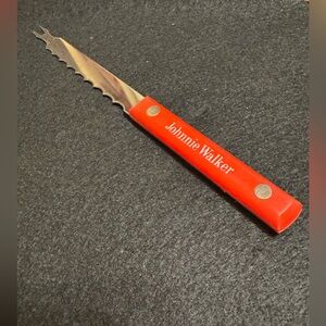 Vintage red handled Johnnie Walker scotch whiskey bar knife